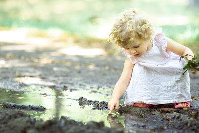 Full length of cute baby girl in water