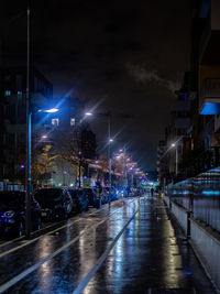Illuminated city street during rainy season at night