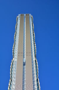 Low angle view of modern building against clear blue sky