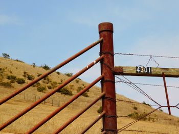Low angle view of metal fence against clear sky