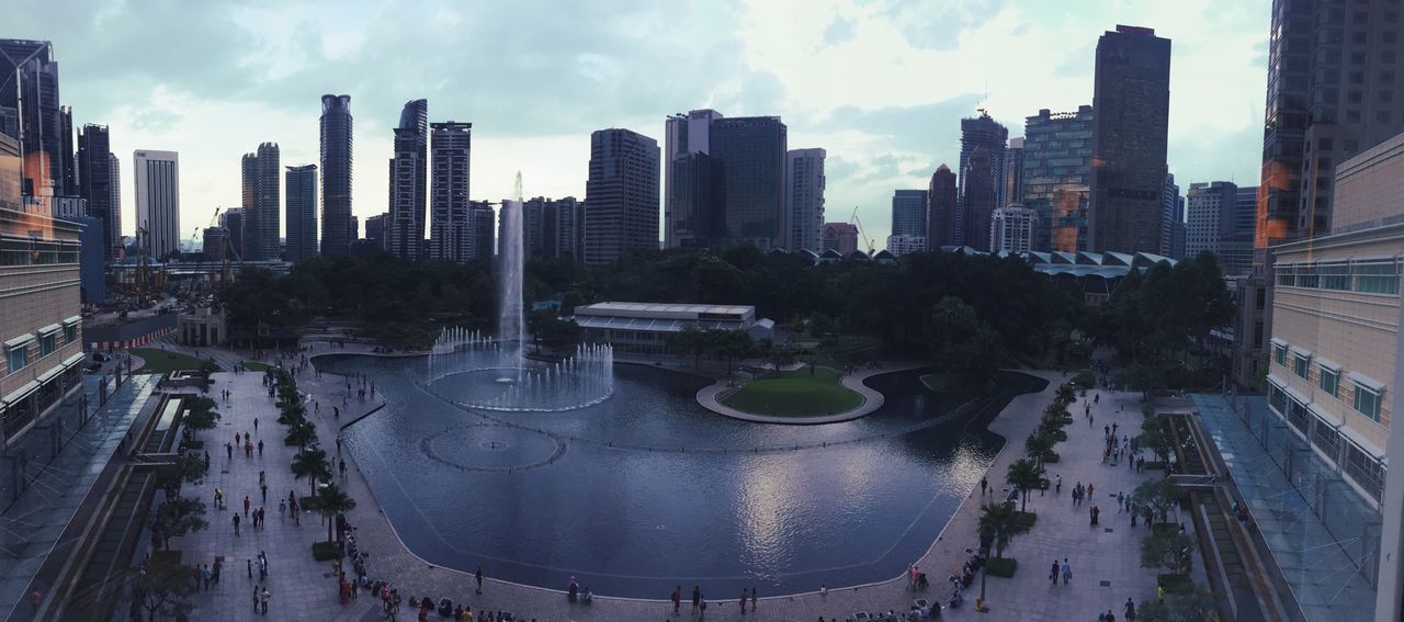 building exterior, city, architecture, built structure, skyscraper, cityscape, water, modern, sky, office building, tall - high, cloud - sky, reflection, river, tower, city life, urban skyline, financial district, transportation, high angle view