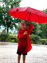 Portrait of a boy holding umbrella