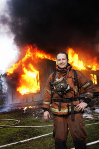 Fire fighter in front of burning buildings