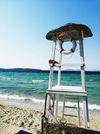 Lifeguard hut on beach against clear sky