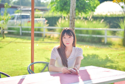 Portrait of young woman reading book