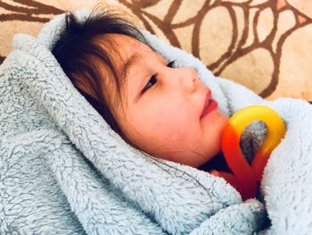 Close-up of baby sleeping in bed