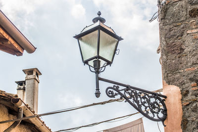 Low angle view of street light against building