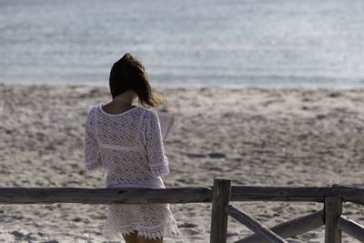 Rear view of woman looking at sea shore