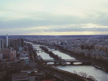 High angle view of river amidst buildings in city against sky