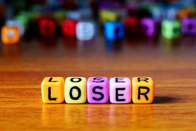 Close-up of text on multi colored toy blocks table