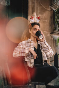 Young girl drinking coffee in cafe
