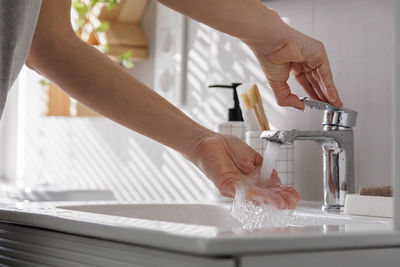 Midsection of man washing hands