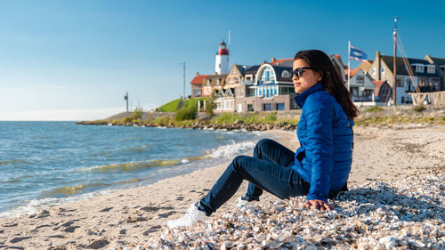 Portrait of young woman sitting on beach