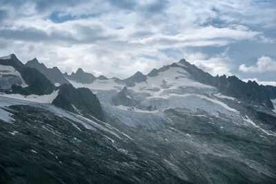 Scenic view of sea and mountains against sky