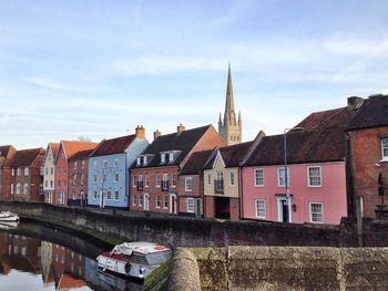 Buildings and cathedral by canal in city