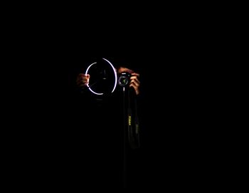 Close-up of electric light bulb against black background