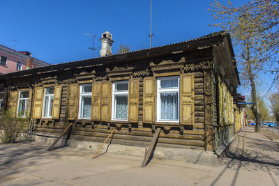 Low angle view of old building against clear blue sky