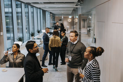 Multiracial delegates discussing during networking conference