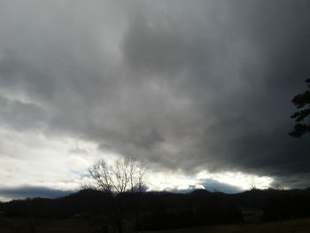 Silhouette of landscape against cloudy sky