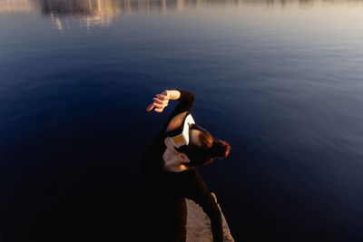 Woman photographing sea