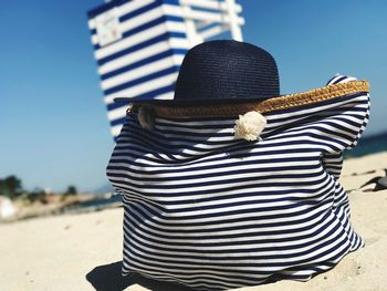 Close-up of hat on beach against sky