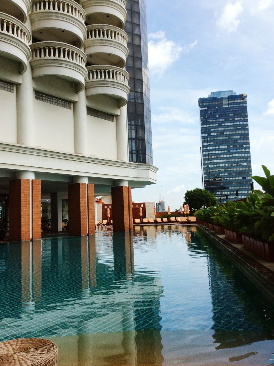 building exterior, architecture, water, built structure, city, sky, reflection, city life, modern, canal, day, outdoors, tall - high, no people, skyscraper, development, cloud - sky, office building, waterfront, building story