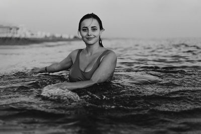 Portrait of young woman swimming in sea