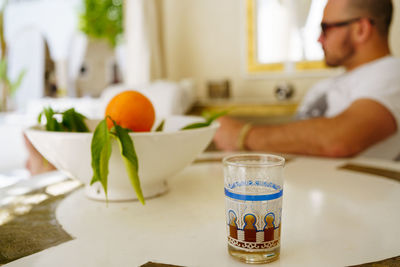 Moroccan tea and orange fruits in a vase in moroccan riad