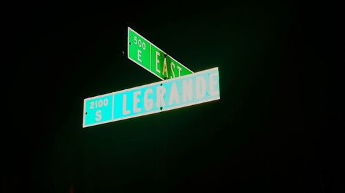 Close-up of information sign against black background