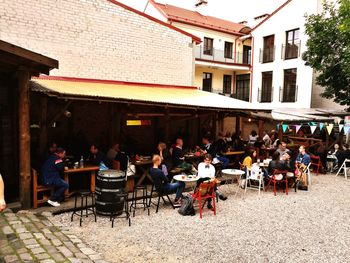 People at sidewalk cafe in city