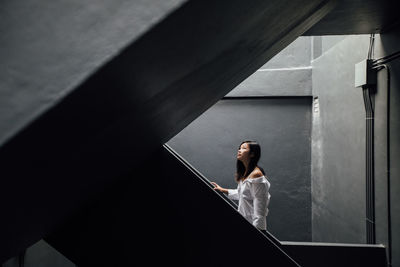 Woman standing on steps in building