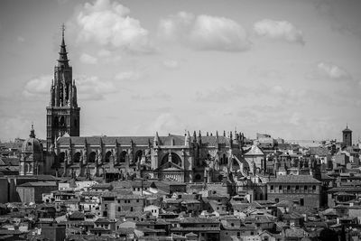 Townscape by cathedral against sky