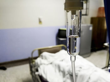 Close-up of electric lamp on bed
