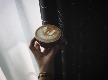 Woman holding coffee cup