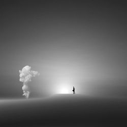 Silhouette of person standing in foggy weather