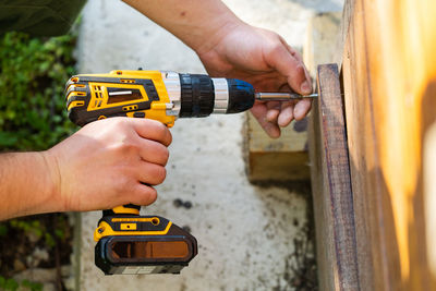 Midsection of man working on wood