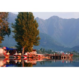 Houses by swimming pool against buildings and mountains