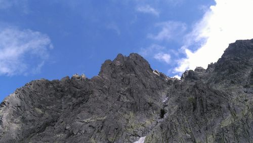 Scenic view of rocky mountains against cloudy sky