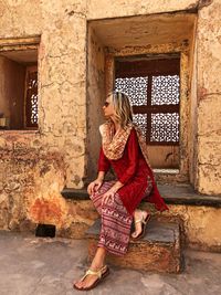 Woman standing at amber fort in city against sky