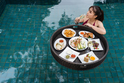 High angle view of young woman having food