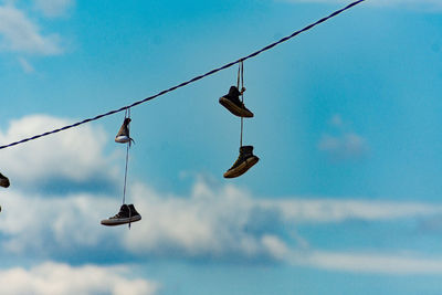 Low angle view of shoes on cable