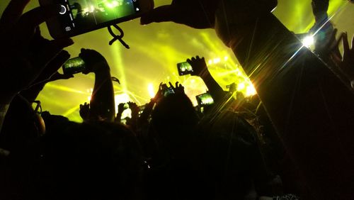 Close-up of silhouette people at music concert