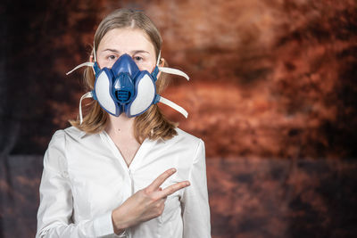 Portrait of a teenage girl against wall