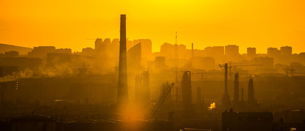 Silhouette buildings against sky during sunset baku gaz oil petrolium