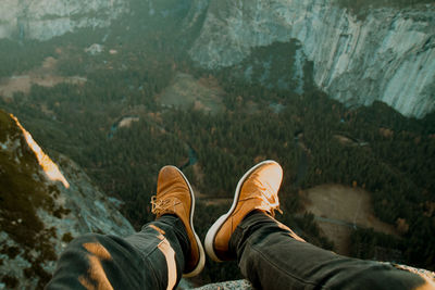 Low section of man sitting on mountain