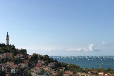 High angle view of city against blue sky