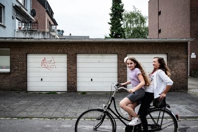 Woman riding bicycle on city street