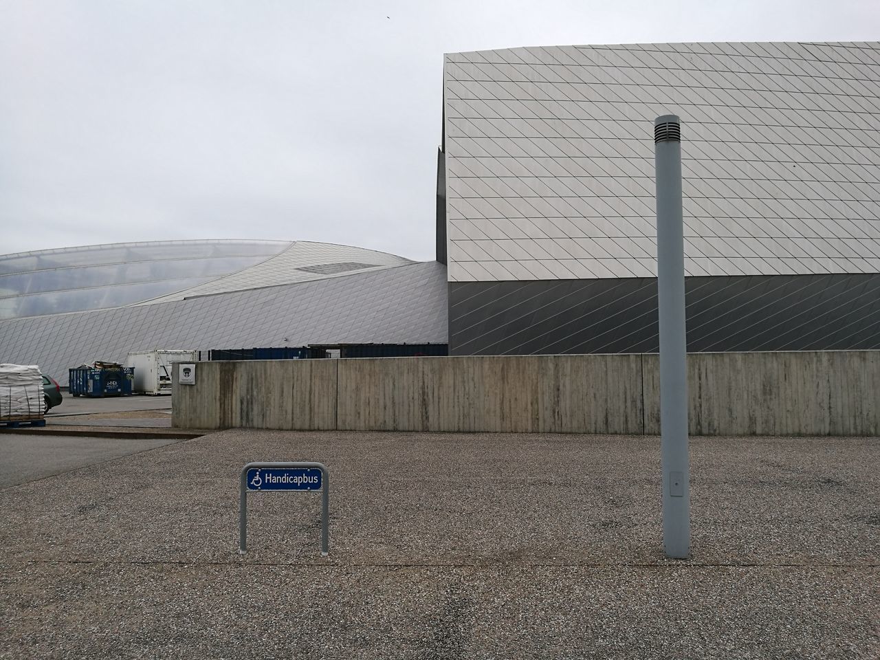 EMPTY ROAD BY BUILDINGS AGAINST SKY