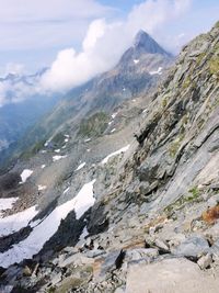 Scenic view of mountains against cloudy sky