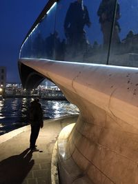 Man walking by sea against sky